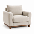 Fauteuil en tissu beige avec pieds en bois